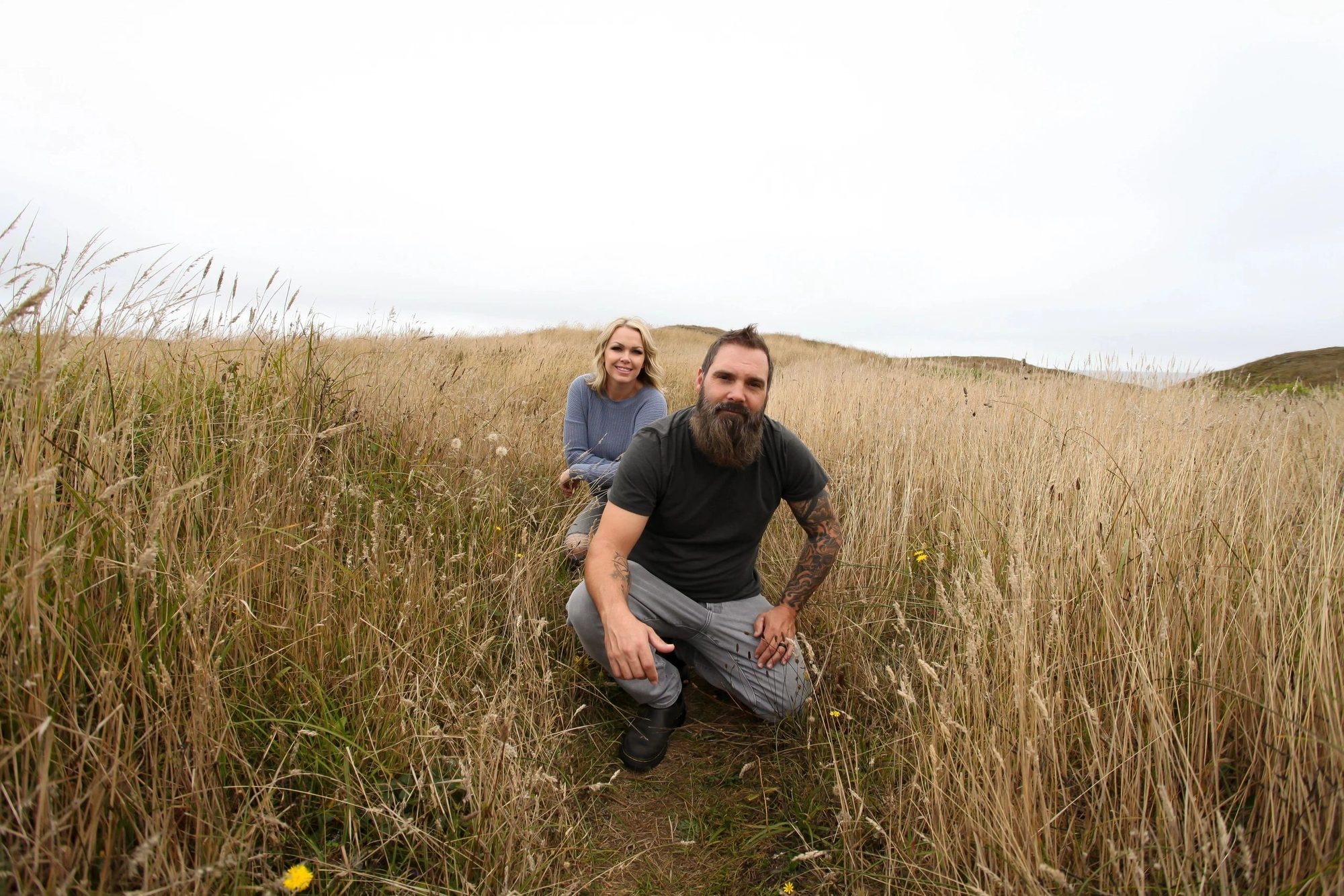 Bradley and Katie Elumbaugh in a golden Idaho field under a wide open sky